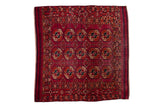 Vintage Turkmen square rug with an allover elephant footprint gul motif in fuchsia, rust, and navy blue.