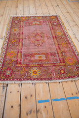 Vintage Anatolian rug fringe, main border with floral and arabesque motifs, visible foundation.