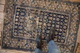 Antique Caucasian rug with serrated leaf border and geometric starburst field design.