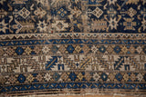 Serrated leaf border and Chichi geometric motifs on an antique Caucasian rug, sapphire blue, beige.