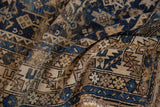 Textured antique Caucasian rug detail: geometric Chichi patterns in sapphire blue and beige.