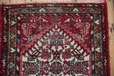 Vintage Persian Borchalou rug detail: Herati pattern in red, beige, blue with visible pile.