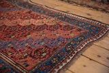Vintage Kurd rug corner with a sapphire blue border, pawn motif, and evenly worn texture.