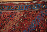 Detail of the vintage rug's pawn motif border and evenly worn pile exposing the knot heads.