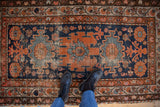 Vintage Hamadan rug, asymmetric flora and geometrics in navy, terracotta, ivory; textured surface.