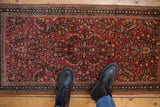 Hand-knotted vintage American Sarouk runner detail, dusty raspberry field with floral vines.