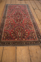 Vintage American Sarouk runner with blossoming vines and floral sprays on dusty raspberry red.