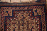 Antique Persian Belouch rug border detail with navy wave and camel geometric patterns.