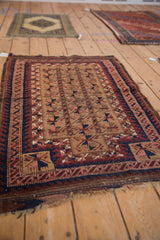 Antique Belouch tribal rug with geometric camel field and a distinctive wave border.