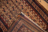 Belouch rug end with tattered fringe, revealing wool foundation and geometric patterns.