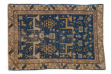 Antique Caucasian rug: deep blue field, geometric animals, tree of life motifs, gold, ivory, brown.