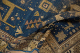 Folded antique Caucasian rug revealing geometric animal figures in deep sky blue and gold.