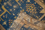 Deep blue field with geometric animal motif, showing antique Caucasian rug's hand-knotted reverse.