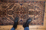 Mohajeran Sarouk rug detail: ivory ground, terracotta, navy floral bouquets, scrolling vines.