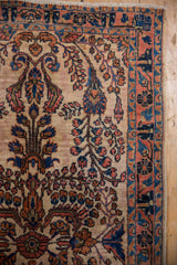 Vintage Mohajeran Sarouk rug detail showing ivory ground, scrolling floral motif, and terracotta navy border.