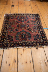 Upper right corner of the vintage Mohajeran Sarouk rug with navy vine border and dusty mauve floral field.