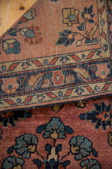 Tightly woven back and floral motifs on dusty mauve pile of vintage Mohajeran Sarouk rug.