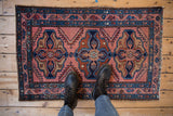 Hand-knotted Mehriban rug featuring triple medallion and arrowed serrated leaves in raspberry and blue.