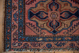 Mehriban rug corner with raspberry field, sapphire blue border, and stable side selvage.
