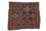 Antique Qashqai Persian rug with repeating geometric panels in sapphire blue, madder red, and chestnut.