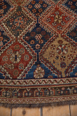 Storied, hand-knotted texture of an antique Qashqai rug with geometric panels and pinwheel motifs.