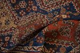 A folded antique Qashqai rug highlighting its supple hand-knotted texture and dense weave.