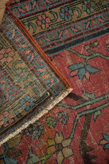 Vintage Heriz runner close-up of red geometric pile, knot heads, and restored selvage.
