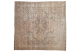 Distressed vintage Kerman carpet, starburst medallion with Rococo stylization and faded floral field.