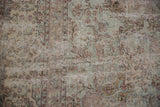 Close-up of distressed Kerman rug pile showing foundation, pale mauve, green, and beige thousand-flower motifs.