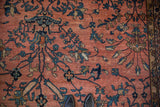 Close-up of vintage Persian Mahal carpet, dusty rose field, sprawling florals, aged patina.