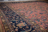 Vintage Persian Mahal carpet detail: navy border with scrolling leaves and blossoms, dusty rose field.
