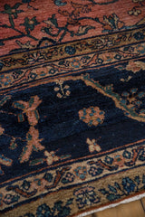 Vintage Mahal carpet, navy field with dusty rose germinating plants and scrolling leaf border.