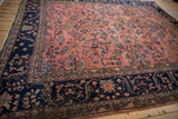 Vintage Persian Mahal carpet's intricate navy border with scrolling blossoms and dusty rose field.