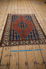 Maslaghan serrated design in brick red and dark navy, bordered by ivory motifs.