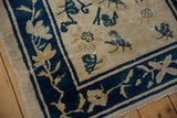 Peking runner corner: cobalt blue vine border, low pile, and scattered leaf motifs.