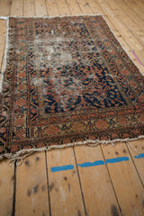 Worn vintage Hamadan rug with extensive foundation wear, threadbare pile, and tattered fringe.