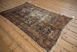 Threadbare early 20th century Hamadan rug detail: Herati motif, navy, rose, foundation, tattered fringe.