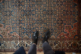 Vintage Malayer rug's sapphire blue Herati design and dusty blush spandrels, with feet.