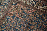 Dusty blush trefoil spandrel and blue Herati field on this Vintage Malayer rug.