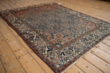 Vintage Malayer rug corner: dusty blush trefoil spandrel, ivory border with blue and red vines.