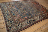Vintage Malayer rug corner with dusty blush trefoil spandrel, blue floral arabesques.