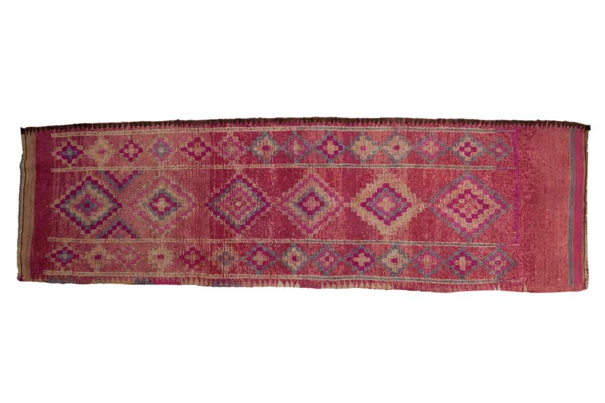 Vintage distressed Kurd runner with geometric diamond medallions in gem-like magenta, slate blue, and ivory tones.