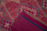 View of the hand-knotted Kurd rug's corner showing the magenta back and original selvage.