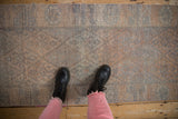 Distressed Kurd runner with geometric blossoms in muted silver and pale tangerine.