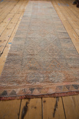 Distressed Kurd rug runner fringe and end, featuring time-softened silver and tangerine tones.