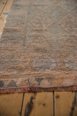 Distressed vintage Kurd rug runner's textured pile and natural fringe detail.