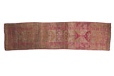 Decoratively distressed vintage Kurd runner with fuchsia and silver geometric patterns and heavy abrashes.