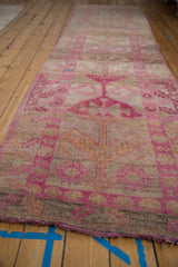 Distressed vintage Kurd runner pile, with fuchsia floral blossoms, guls, and visible abrashes.