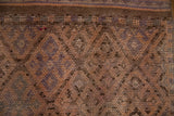 Distressed vintage Kurd runner with worn knot heads, showing muted geometric patterns and varied earth tones.
