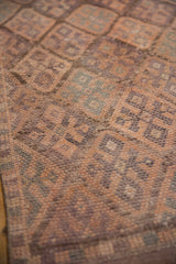 Distressed Kurd runner pile, geometric lattice in coffee brown and muted violet tones.